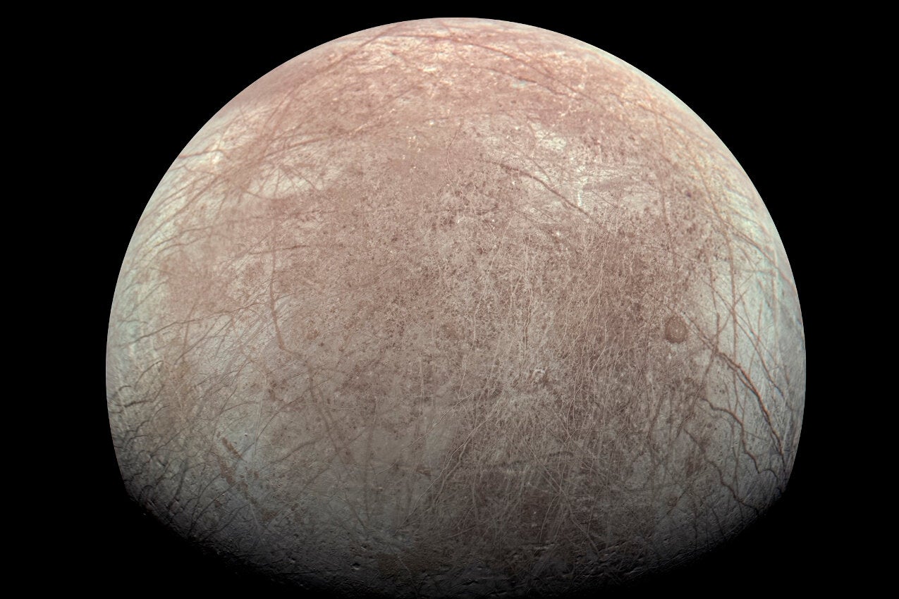 The Jupiter moon Europa captured by the Juno spacecraft during a flyby in 2022. Oceans of water slosh beneath Europa’s surface under a shell of ice that could be more than 10 miles thick.