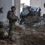 Israeli soldiers during a military tour for journalists of a tunnel under a U.N. site in Gaza. The Times later found that a Palestinian had been forced to explore the tunnel.